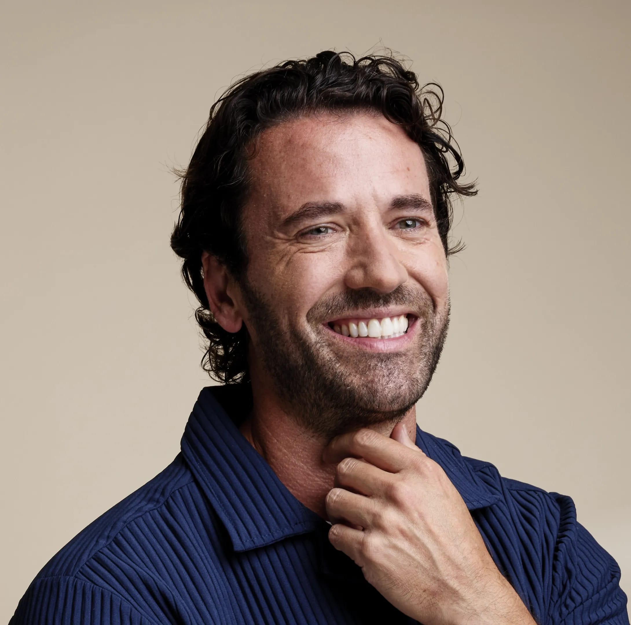 IU man smiling after porcelain veneers