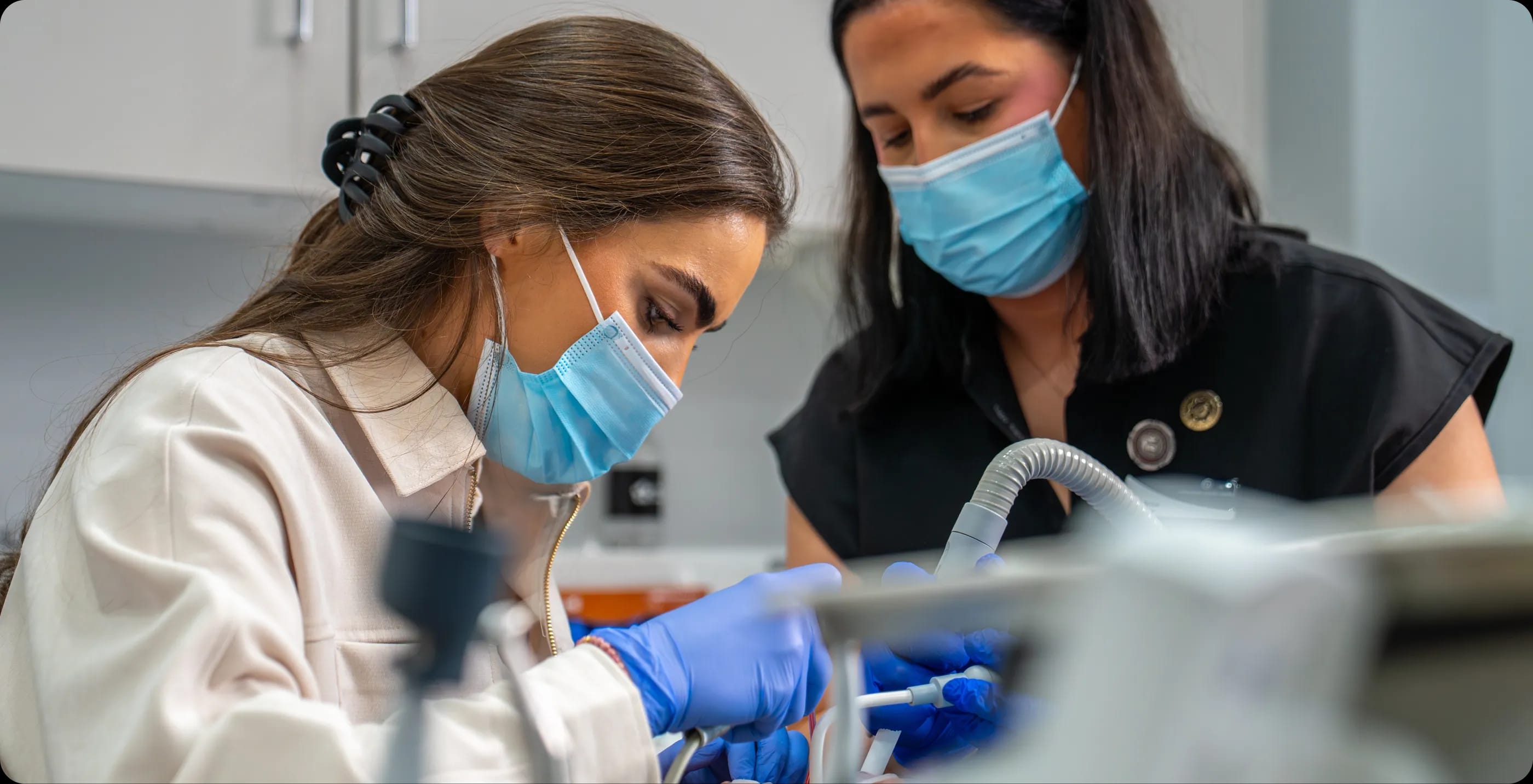 Qualified nurses helping during a dental procedure